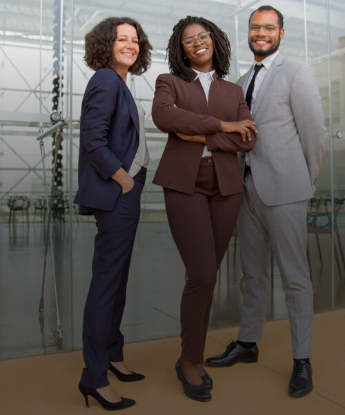 Cheerful multiethnic business team Cheerful multiethnic business team. Full length view of professional businessman and businesswomen standing together and smiling at camera. Teamwork concept
